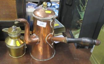 A copper jug, with side handle, together with a brass jug