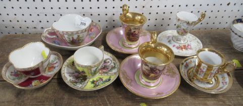 Seven decorative cabinet cups and saucers