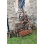 A leather sewing machine, feeding troughs , collection of tools, lawn mower, distressed condition