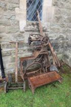 A leather sewing machine, feeding troughs , collection of tools, lawn mower, distressed condition