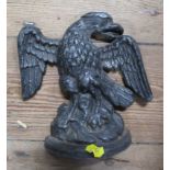 A wrought iron door stop, modelled as an eagle, height 8ins