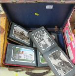 A collection of postcard albums together with a leather case