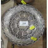 A circular silver shallow dish, with embossed decoration, weight 4oz