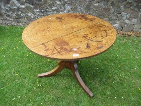 An oak tripod table diameter 35ins height 28ins