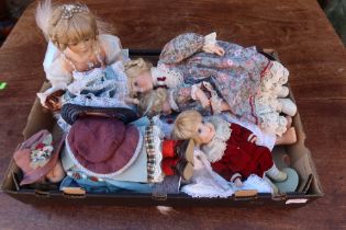 A box of assorted dolls etc