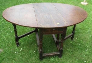 An Antique oak gateleg dining table, fitted with a drawer, 42ins x 56ins, height 27ins