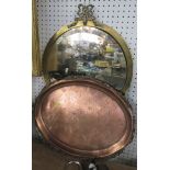 A brass framed wall mirror, together with a copper oval tray