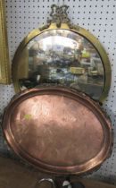 A brass framed wall mirror, together with a copper oval tray