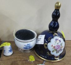 A porcelain bell, together with a porcelain pin cushion and a thimble