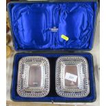 A cased pair of rectangular silver dishes, with pierced border, weight 3oz