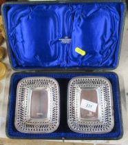 A cased pair of rectangular silver dishes, with pierced border, weight 3oz