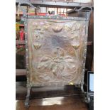 An Arts and Crafts copper and metal fire guard, the copper panel with embossed lily and pad