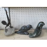 Two Canadian stone carvings, of a seal and a bird, labels to base, together another sculpture of a