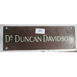 A metal Doctor's name plaque