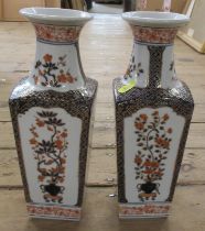 A pair of vases decorated with iron reds and blues height 12.5ins