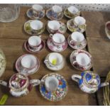 13 Continental miniature cups and saucers, together with two miniature tea pots