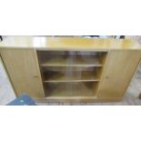 An oak bookcase, with sliding glass doors and cupboard, width 53.5ins, depth 11ins, height 30.5ins