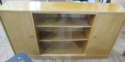 An oak bookcase, with sliding glass doors and cupboard, width 53.5ins, depth 11ins, height 30.5ins