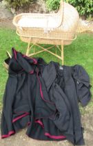 A wicker cot/Moses basket, on stand, together with a hooded cape, a university black gown and a coal