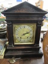 An oak cased mantel clock