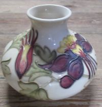 A Moorcroft Pottery vase, decorated in the Columbine pattern, height 5ins