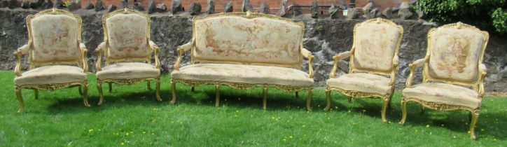 A late 19th century Louis XV style five piece salon suite, comprising a canape and four fauteils,