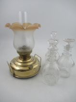 An oil lamp and three decanters