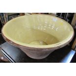 A large terracotta dough bowl, with glazed interior, width 21ins