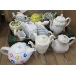 A collection of tea pots, to include novelty ones, together with a collection of pottery pebble