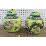 A pair of covered ginger jars, decorated with dragons to a yellow ground, af, height 6.25ins