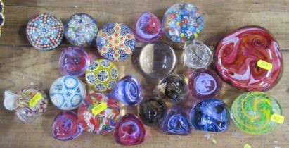 A collection of glass paperweights, and a jug