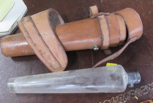 A hunting conical shaped glass flask, with leather case and fittings to attach to a saddle