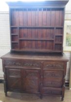 A Welsh style oak dresser, with shelves to the rack back, fitted with a cupboard and drawers with