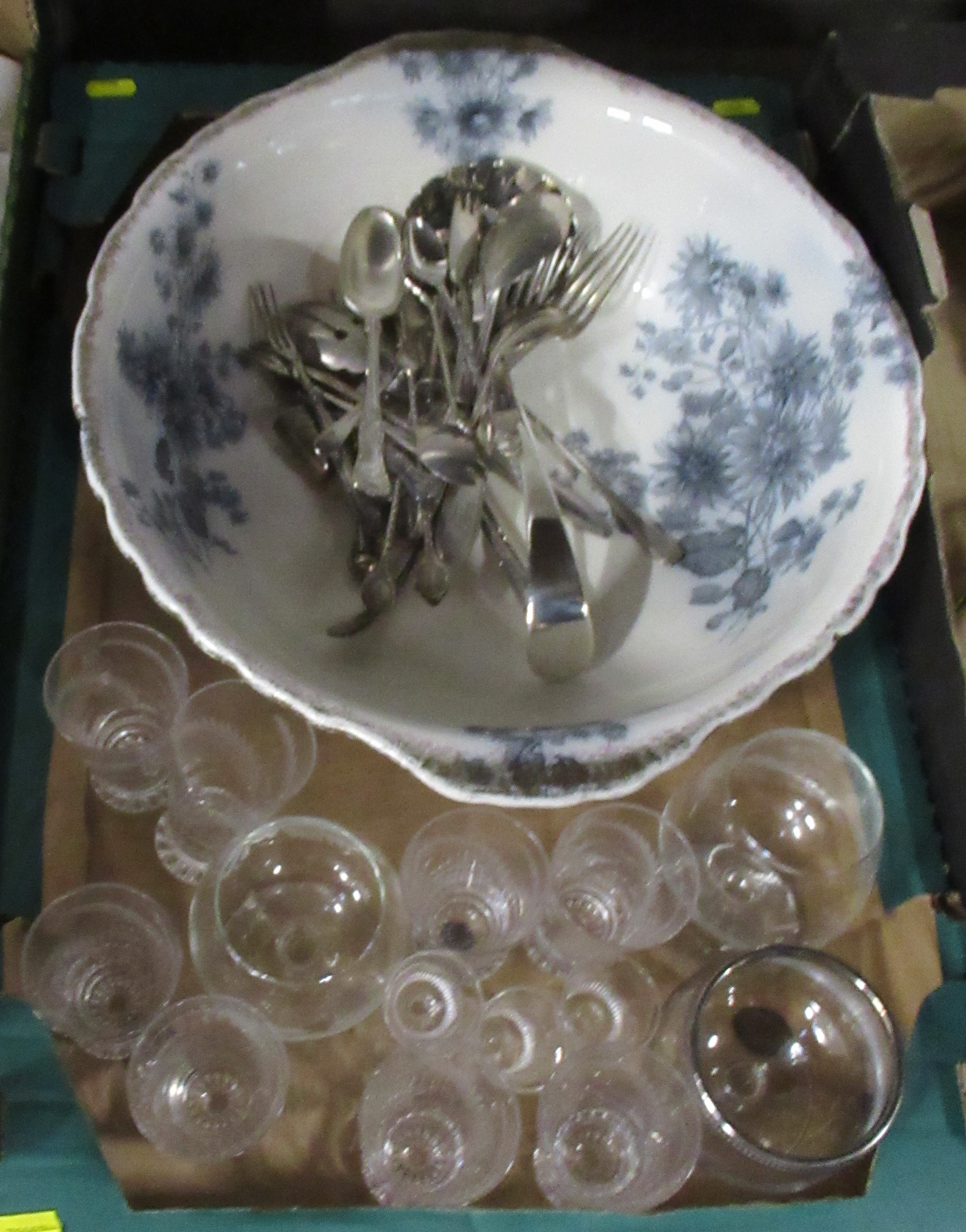 A box of assorted items. to include a wash bowl, glasses, flatware