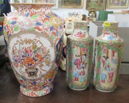 A pair of Oriental cylindrical vases, decorated with panels of birds and figures, height 10ins,