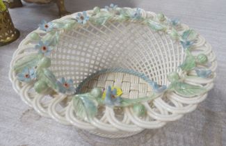 A Belleek porcelain basket weave bowl, decorated with coloured flowers, diameter 6ins, height 2.