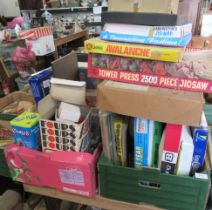 A collection of vintage board games and toys, including racing related games and Britains toys