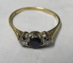 An 18ct gold ring, set with a sapphire and two diamonds