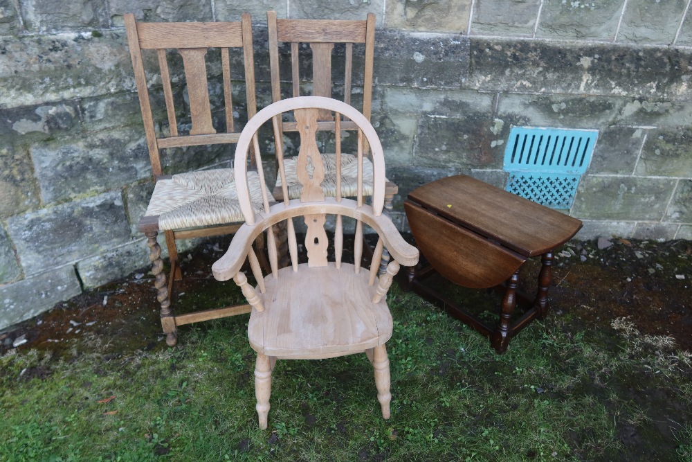 A child's Windsor arm chair together with two cane seated chairs and an occasional table