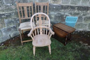 A child's Windsor arm chair together with two cane seated chairs and an occasional table