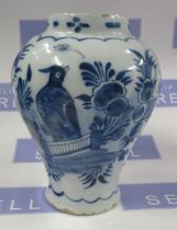 An Antique Delft vase, decorated with a bird and foliage in blue and white, height 7.5ins
