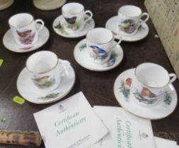 A set of six Royal Worcester Compton and Woodhouse coffee cans and saucers, decorated with birds,