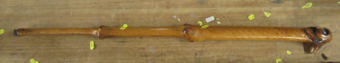 A carved wooden walking stick, with face pommel, length 34ins