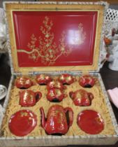 A boxed Japanese lacquered tea set, with tray