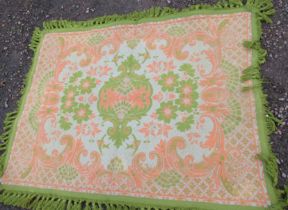 A green and peach ground rug, 55ins x 72ins and another orange example