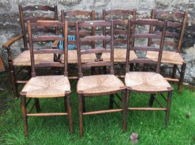 A set of four (3+1) oak ladder back chairs, with rush seats, together with another set of three