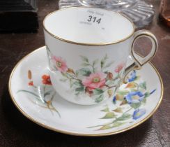 A Royal Worcester cup and saucer decorated with flowers
