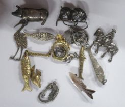 A pig vesta case, together with fish brooches, keyrings and other items