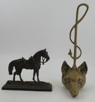 A brass door stop, modelled as a fox's mask and scroll tail, together with another metal horse