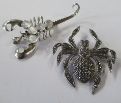 A scorpion brooch, set with moonstone type stones, together with a spider brooch